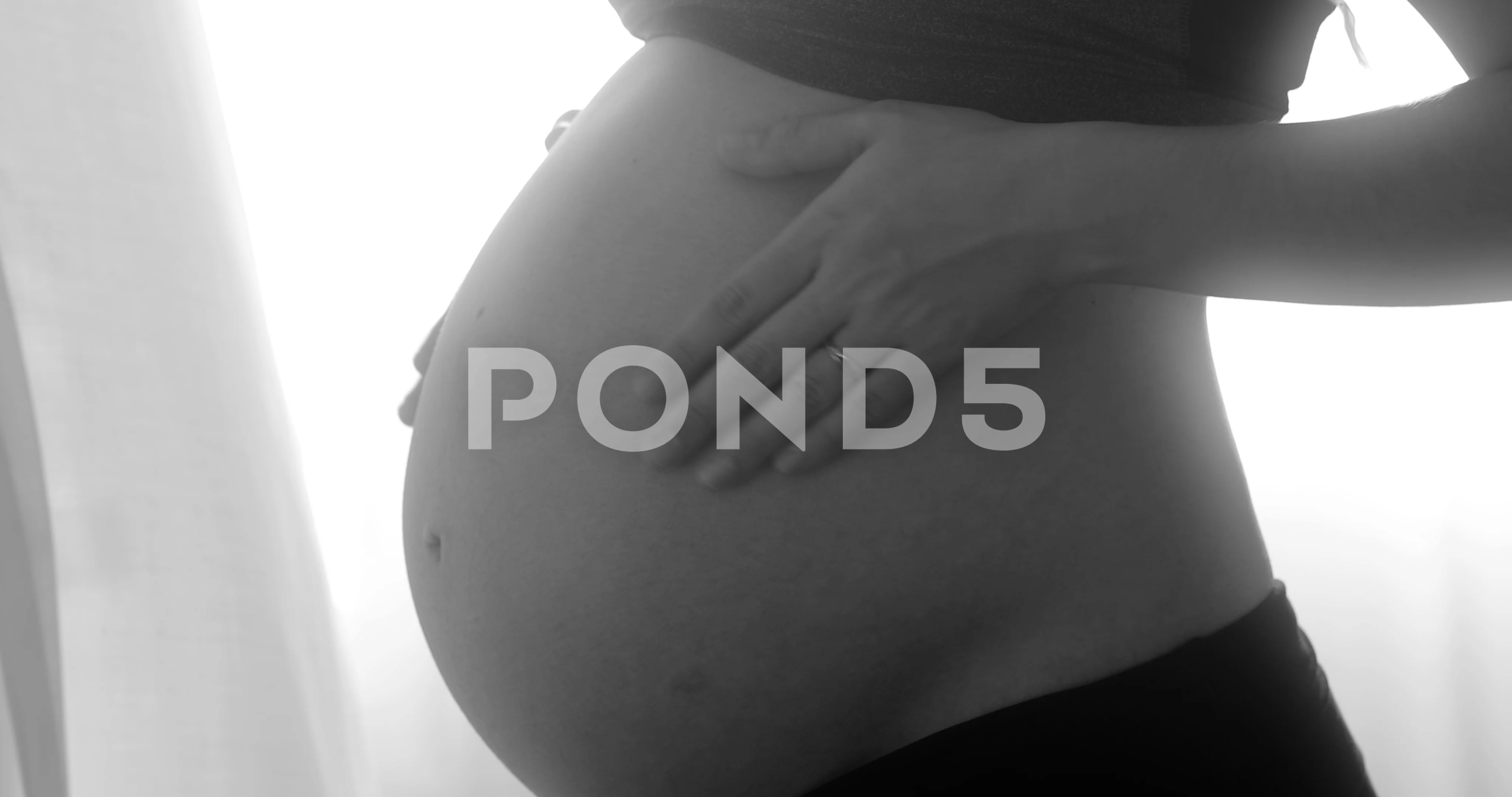 Woman cuddling pregnant belly. Black and, Stock Video