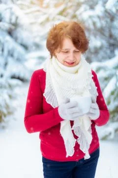 Woman with a cup of tea in the winter outdoors Stock Photos