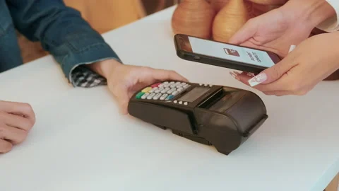 Woman customer using QR code payment via smartphone for paying at shop Stock Footage 236259322