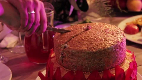 A woman cuts a cake on the table Stock Footage 159897702