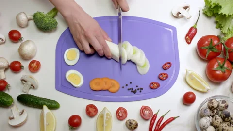 Woman cuts leeks into thin slices with sharp knife Stock Footage 229724786