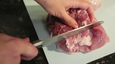 Woman cuts meat in the kitchen 스톡 동영상 87167360