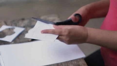 The woman cuts out a cloud from paper. Stock Footage 102776010