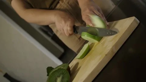 Woman cutting apple on the table Stock Footage 140600976