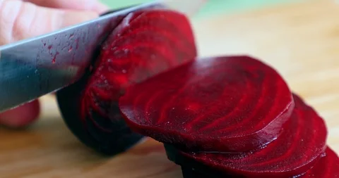 A woman cutting Beetroot vegetable on circles pieces with knife Stock Footage 88316701