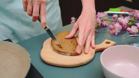 Woman cutting core out of bread slice in kitchen Stock Footage 342863265