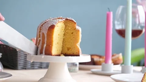 Woman cutting Easter cake on dinner table Stock Footage 303637429