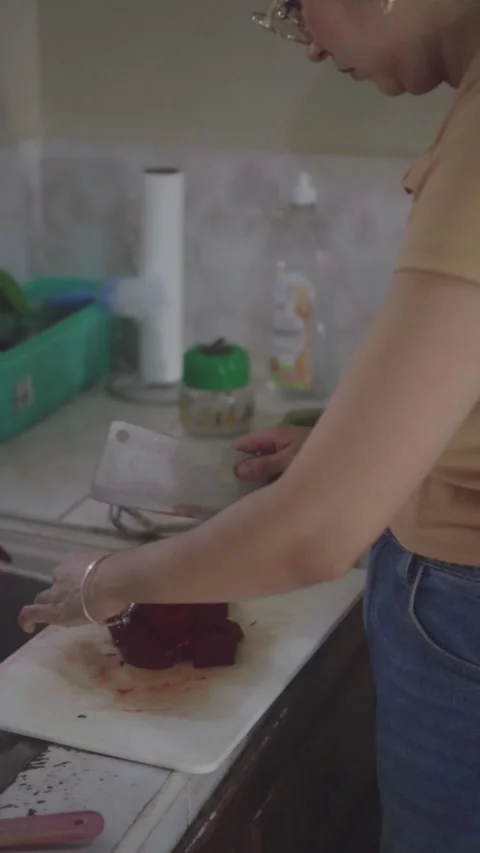 Woman cutting fresh red beetroot with a cleaver Stock Footage 341893055