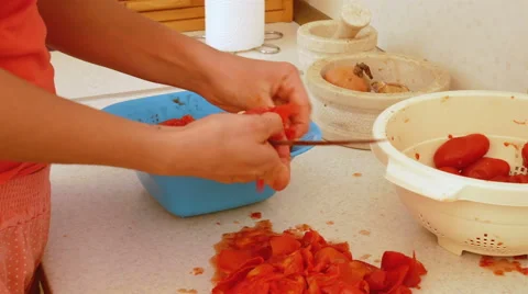 Woman cutting fresh tomatoes for sauce Stock Footage
