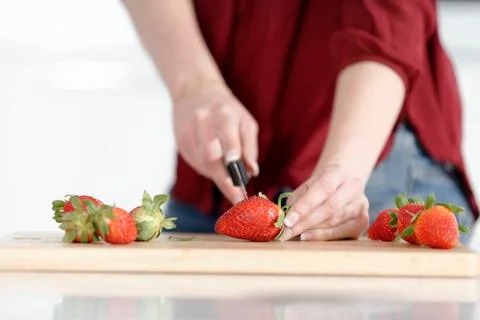 Woman cutting up fruit Stock Photos
