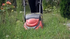 1960s: A shiny yellow lawnmower on a gra, Stock Video