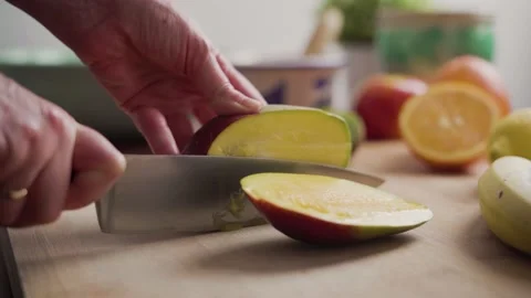 Woman cutting a mango Stock Footage