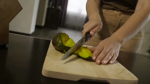 Woman cutting mango on the table Stock Footage 140600526