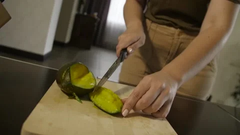 Woman cutting mango on the table Stock Footage 140600552