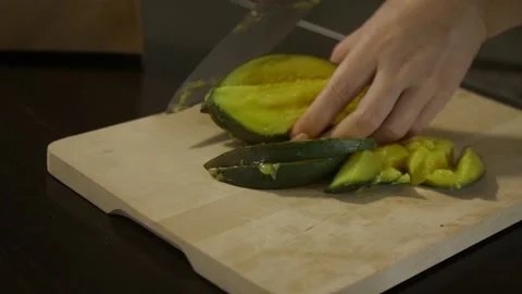 Woman cutting mango on the table Stock Footage 140600646