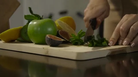 Woman cutting mint on the table Video stock 140601906