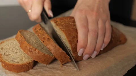 A woman is Cutting rye bread Stock Footage 126752855