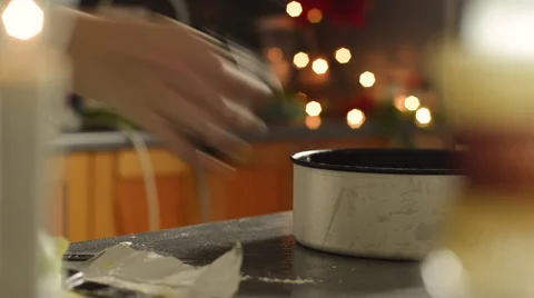 Woman cutting a section of baking sheet Stock Footage 55555556