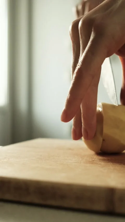 Woman cutting vegetable on table in kitchen Stock-Footage 168506018