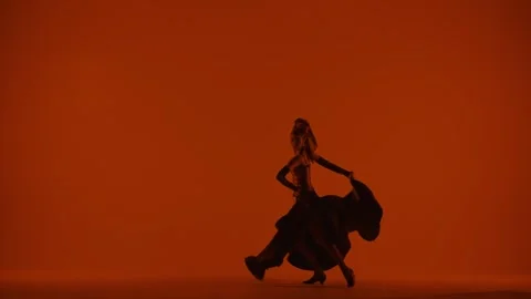 Woman dancer dancing on red background. Female in flamenco style dress performs Stock Footage 263903472