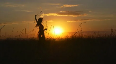 Woman dancer performs a fire show in front of the sun Stock Footage 67627308