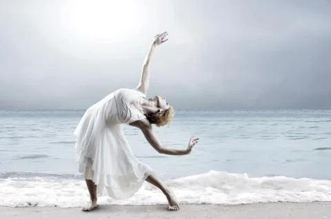 Woman dancer posing on the beach Stock Photos