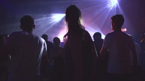 A woman dances and has fun with her friends in a nightclub Stock Footage 237678380