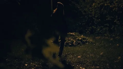A woman dances in the dark under the light of a lantern Stock Footage 83623282