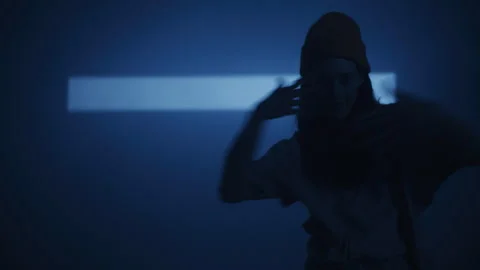 Woman Dancing and Looking At Camera in blue Studio Lighting 库存影片 259136045