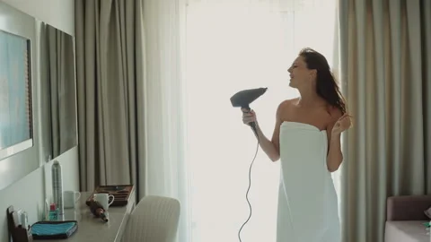 Woman dancing and singing using hair dryer Video stock 104652758