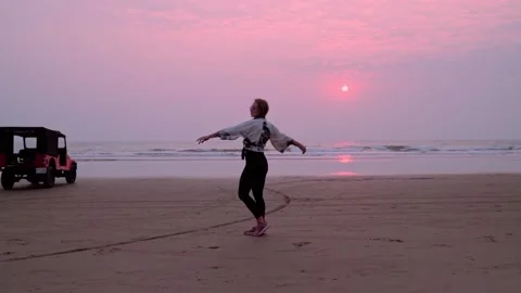 Woman is dancing on the beach Stock Footage 149879536