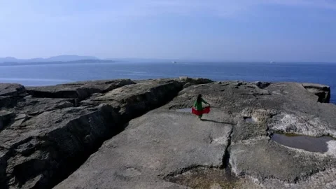 Woman dancing on cliffs by the sea Stock Footage 167587005