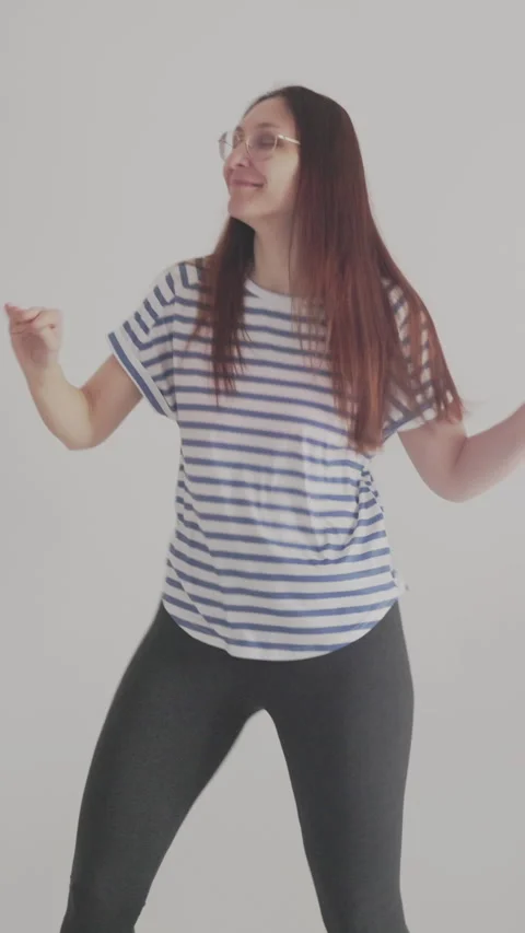 Woman dancing energetically in home studio with led light Stock Footage 326823325