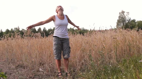 A woman is dancing in a field of rye, wheat Video stock 45375856