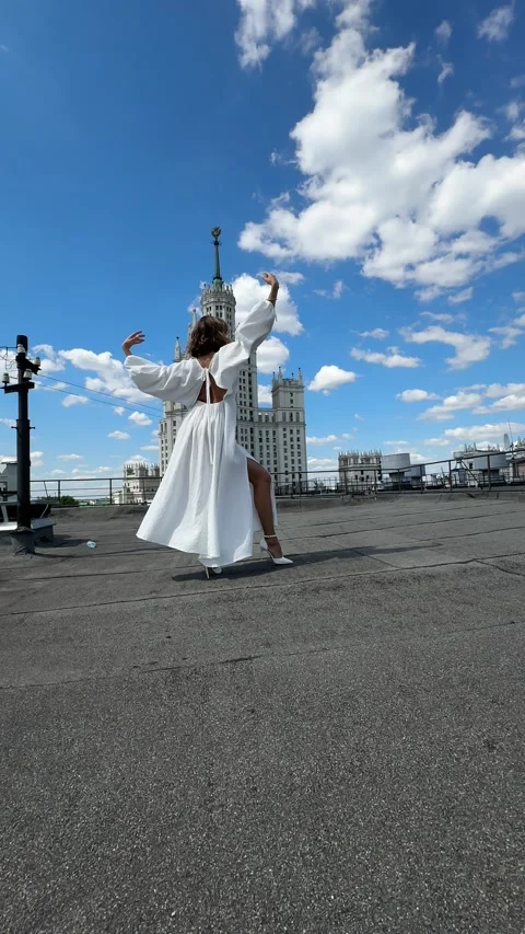 Woman dancing on a rooftop, bride, white dress Stock Footage 313503483