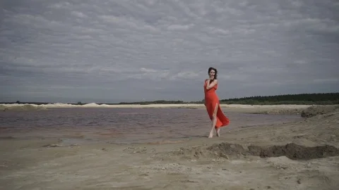 Woman dancing on seashore Видео 80759587
