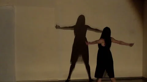 Woman dancing with shadow on wall Stock Footage 62184008