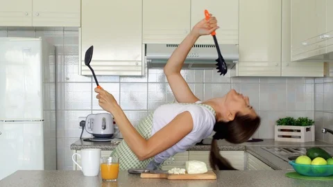 Woman dancing silly on kitchen. Funny female enjoy herself moving ridiculously Stock Footage 101846676