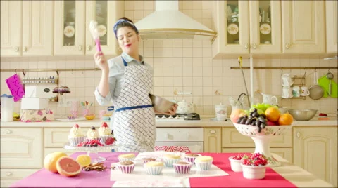 Woman dancing while cooking Stock Footage 62746479