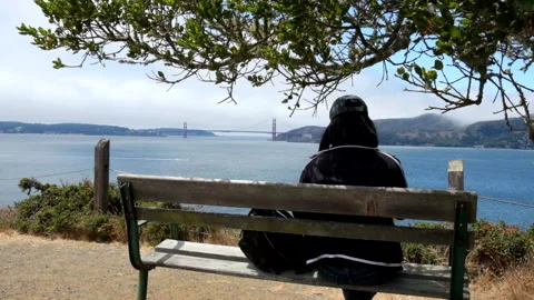 Woman with dark hair looking at the golden gate bridge Stock Footage