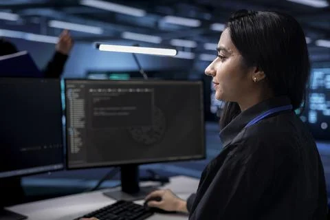 Woman in data center looking for errors causing equipment to slow down 写真素材