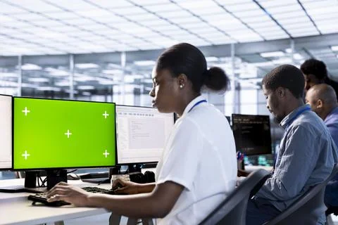 Woman in data center updating systems on isolated screen PC 写真素材