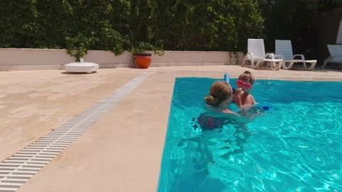 Woman With Daughter In The Pool Stock Footage 158666341