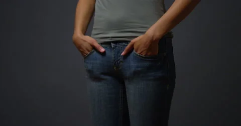 Woman in debt pulling out empty pockets Video stock 44493707