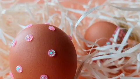 Woman decorates Easter egg with pink rhinestones. Stock Footage 104589654
