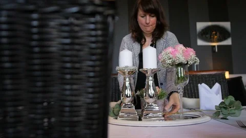 A woman decorates the table for a wedding Stock Footage 88566672