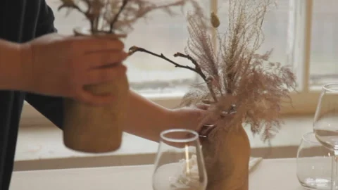Woman decorating a table setting with dried flowers Stock Footage 168331248