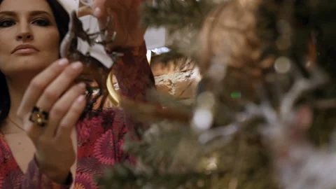 Woman is decorating the tree Stock Footage 85882610