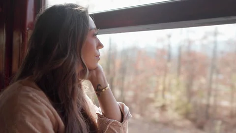 A Woman Deeply Contemplating While Gaze is Fixed Out of the Window into the Stock Footage 305489587