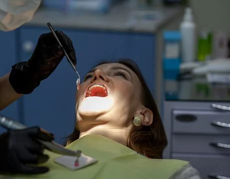 A woman at a dentist's appointment to replace arches with braces Stock Photos